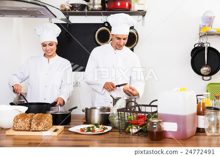 Two chefs preparing food Two chefs preparing food 24772491