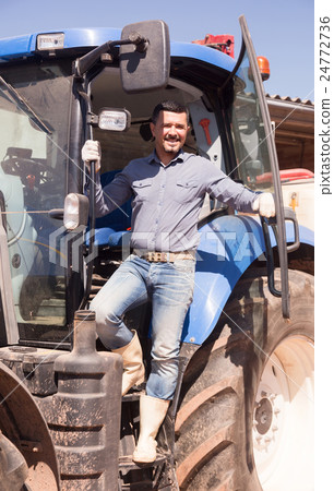 Mature farmer near tractor. 24772736