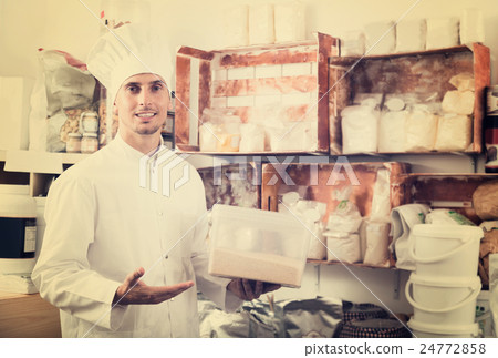 cook taking flour in pantry room. cook taking flour in pantry room. 24772858