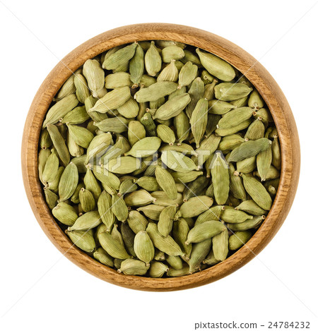 Cardamom pods in a bowl over white Cardamom pods in a bowl over white 24784232