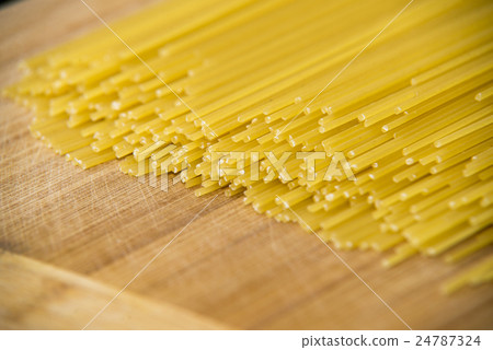 Bunch of spaghetti on wood background Bunch of spaghetti on wood background 24787324