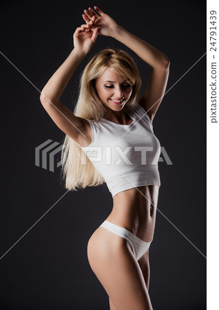 sexy fitness woman pulling hair on dark studio sexy fitness woman pulling hair on dark studio 24791439