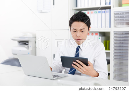 Businessmen using tablets Businessmen using tablets 24792207