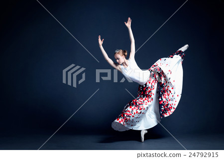 Young ballerina is dancing in a dark photostudio Young ballerina is dancing in a dark photostudio 24792915