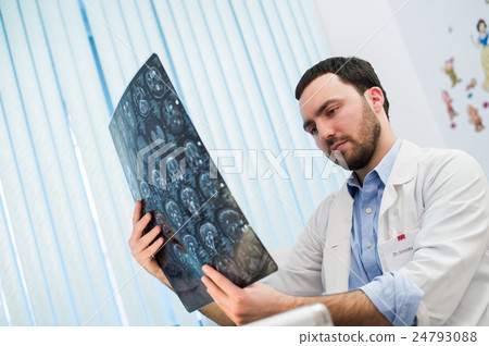 Doctor viewing mri x-ray of brain in office Doctor viewing mri x-ray of brain in office 24793088