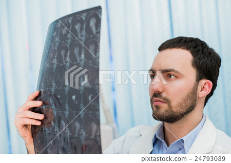 Doctor viewing MRI scans at his office Doctor viewing MRI scans at his office 24793089