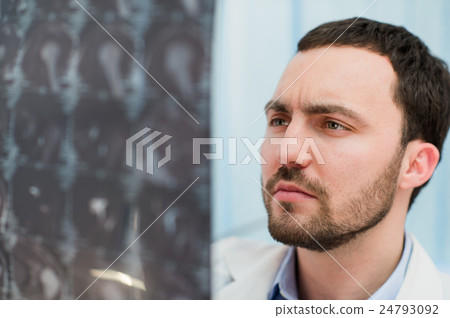 Doctor viewing mri x-ray of brain in office Doctor viewing mri x-ray of brain in office 24793092