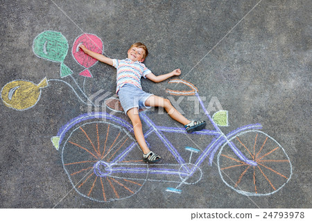 little kid boy having fun with bike chalks picture 24793978