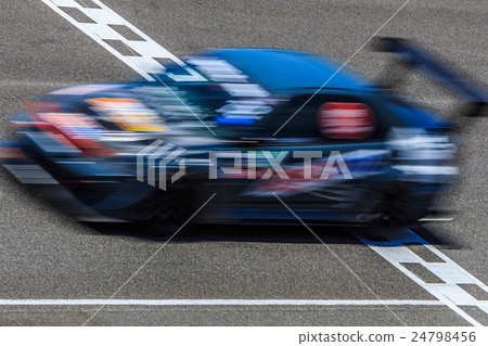 Race car racing on speed track with motion blur cr 24798456