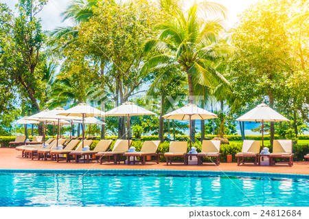 Umbrella and chair around swimming pool Umbrella and chair around swimming pool 24812684