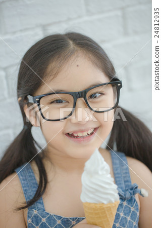 Happy Asian girl enjoy eating soft ice-cream Happy Asian girl enjoy eating soft ice-cream 24812935