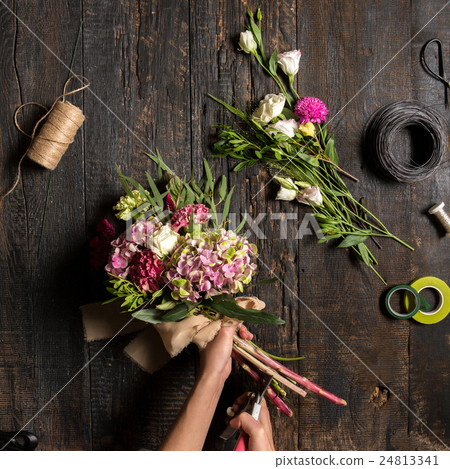 The florist desktop with working tools and ribbons The florist desktop with working tools and ribbons 24813341