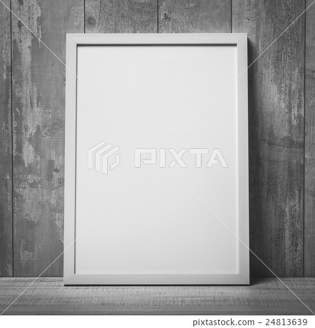 Blank white picture frame on the wall and the 24813639