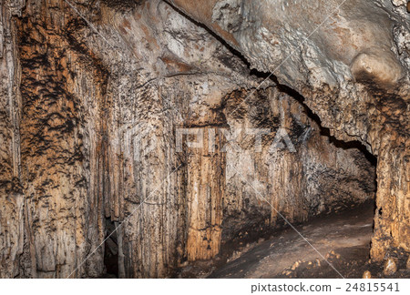 Passage in a deep cave. Stone block wall. 24815541