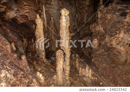 High mineral stalagmites inside the dark cave 24815542