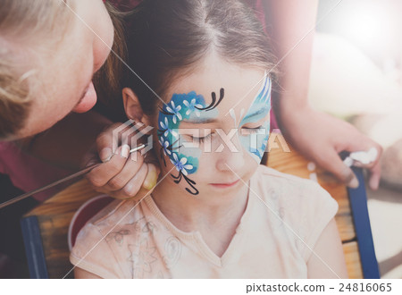 Female child face painting, making butterfly Female child face painting, making butterfly 24816065