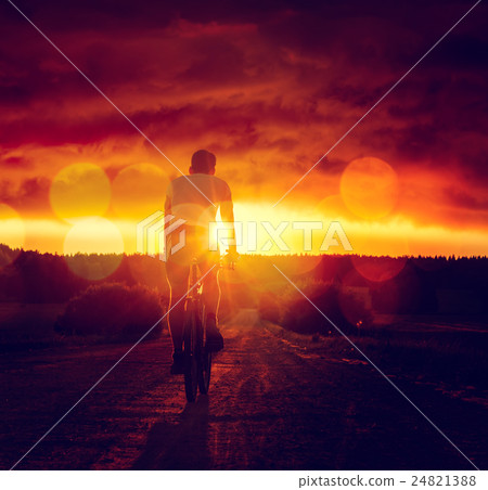 Man Riding a Bicycle at Sunset Man Riding a Bicycle at Sunset 24821388