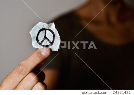 man with a peace symbol in a piece of paper 24821421