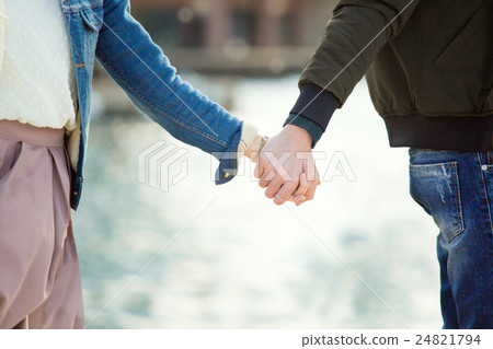 A couple connecting hands to do a date 24821794
