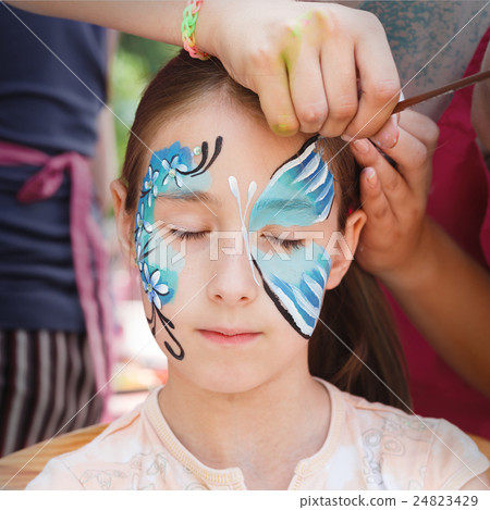 Female child face painting, making butterfly Female child face painting, making butterfly 24823429