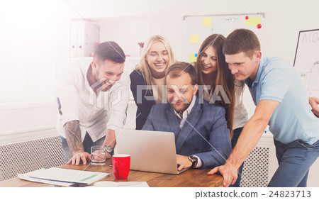 Happy business people team together look at laptop Happy business people team together look at laptop 24823713
