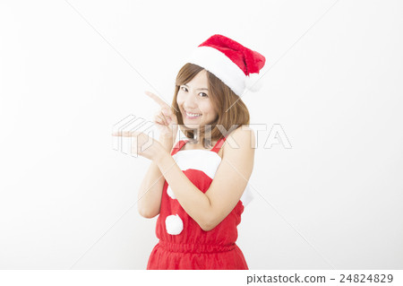 Women Christmas Santa Claus costume pointing fingering both hands both fingers recommendation white wall 24824829
