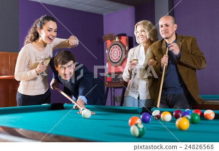 Group of adults playing pool. 24826568
