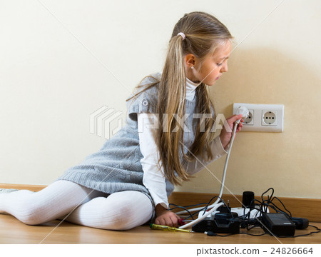 Little girl playing with sockets at home. Little girl playing with sockets at home. 24826664