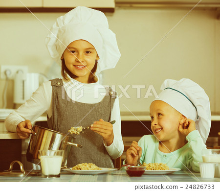 girls having breakfast with porridge 24826733