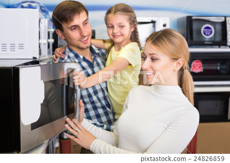 Portrait of family selecting microwave 24826859