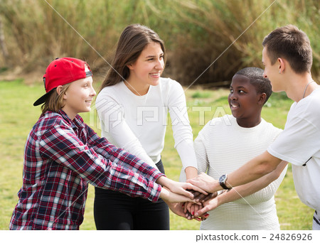 Four friends on countryside field Four friends on countryside field 24826926