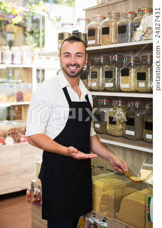 Seller standing with cereals sold 24827431