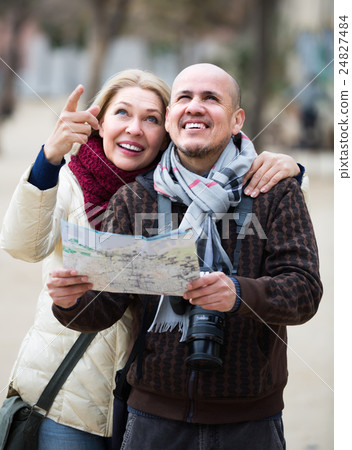 Senior couple of travellers with map . 24827484