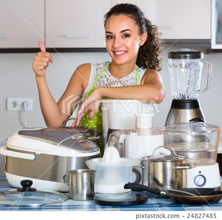 Girl with kitchen appliances at home. 24827485
