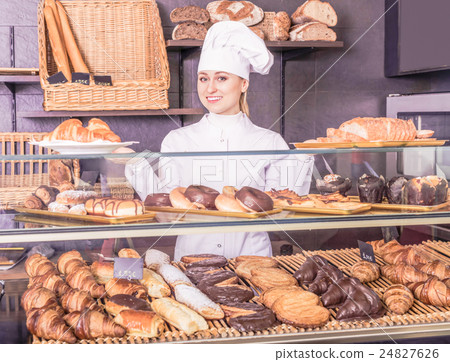 Girl offering desserts in the pastry shop . 24827626