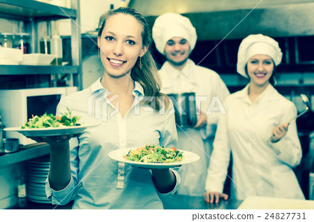 Chefs and waitress at kitchen 24827731
