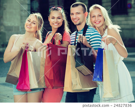 Four people holding paper bags Four people holding paper bags 24827836
