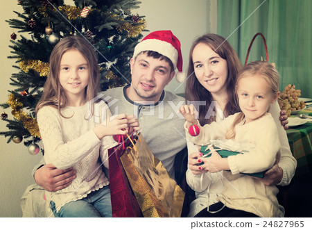 Happy family with Christmas tree Happy family with Christmas tree 24827965