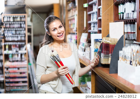 Nice woman shopping various paintbrushes Nice woman shopping various paintbrushes 24828012