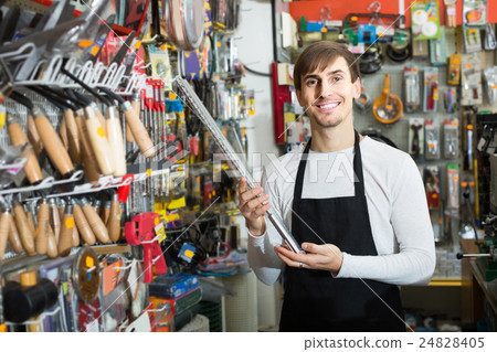 male seller posing at tooling section of household store male seller posing at tooling section of household store 24828405