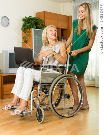 Social worker and invalid with laptop Social worker and invalid with laptop 24828477