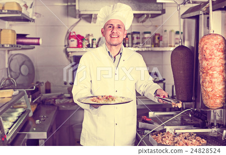 man chef serving fresh kebab 24828524