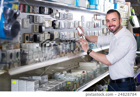 glad man picking electric plug in household shop 24828784
