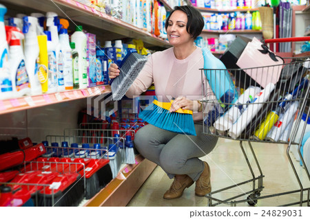 Adult woman choosing cleaning brush 24829031