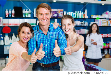 Smiling parents with girl teenager holding thumbs up Smiling parents with girl teenager holding thumbs up 24829129