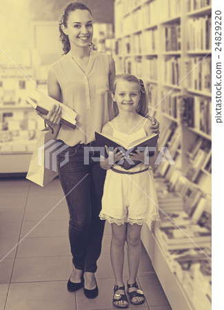 Woman showing open book to little girl 24829220