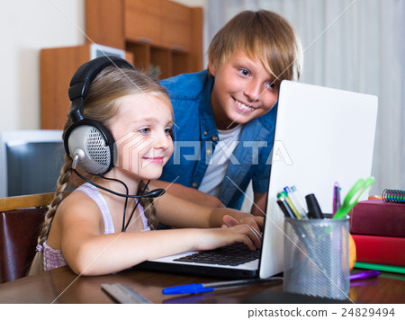 Children playing online game. 24829494