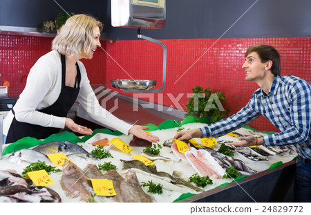 Customer buying fish in shop. Customer buying fish in shop. 24829772