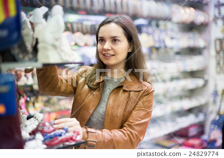 Female customer in souvenir shop. 24829774