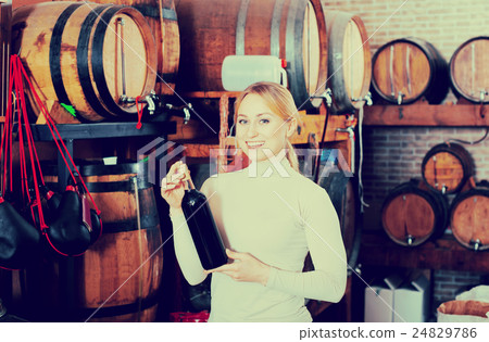 Woman having glass of wine in wine house Woman having glass of wine in wine house 24829786